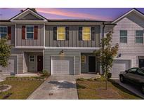 Two-story townhome with attached garage and landscaping at 3511 Lakeview Crk, Lithonia, GA 30038