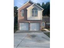 Two-story brick home with a two-car garage at 6258 Crooked Creek Dr, Rex, GA 30273