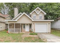 Tan two-story house with attached garage and porch at 217 Maple Nw St, Atlanta, GA 30314