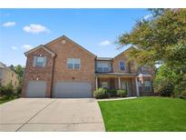 Brick house with a three-car garage and a well-maintained lawn at 146 Elmsdale Ln, Atlanta, GA 30213