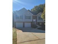 Two-story house with double garage and brick accents at 15 Lumby Ln, Covington, GA 30016