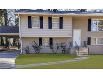 Two-story home with brick facade and landscaped yard at 2900 Bradmoor Ct, Decatur, GA 30034