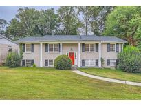 Brick ranch house with red door and landscaping at 3993 Snapfinger Way, Decatur, GA 30035