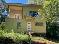 Modern two-story home with large windows and deck at 1787 Pennington Se Pl, Atlanta, GA 30316