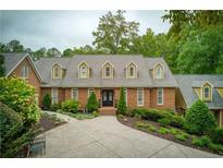 Two-story home with brick facade, landscaping and a driveway at 2601 County Line Nw Rd, Acworth, GA 30101