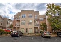 Tan 3-story building with balconies and parking at 238 Walker Sw St # 32, Atlanta, GA 30313