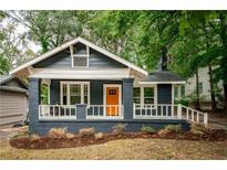 Charming renovated bungalow with a welcoming front porch and landscaped yard at 943 Rose Sw Cir, Atlanta, GA 30310