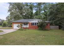 Brick ranch house with attached garage and landscaping at 6531 Temple St, Lithia Springs, GA 30122