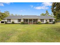 Ranch-style home with large front yard and mature landscaping at 273 Ralston Rd, Powder Springs, GA 30127