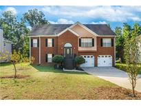 Brick house with two car garage and landscaping at 4069 High Country Dr, Douglasville, GA 30135
