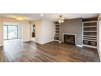 Living room with fireplace and built-in shelving at 801 River Mill Cir, Roswell, GA 30075
