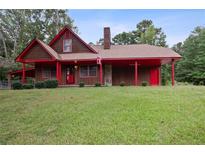 House exterior featuring a brown wooden facade with red accents at 6945 Butner Rd, Atlanta, GA 30349