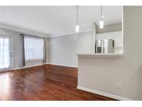 Bright living room with hardwood floors and kitchen bar at 2700 Pine Tree Rd # 2215, Atlanta, GA 30324