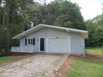 Ranch home with attached garage and small front porch at 2585 Westchester Dr, Atlanta, GA 30344