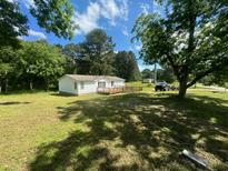 Single wide mobile home with deck and yard at 3600 Grady Smith Rd, Loganville, GA 30052