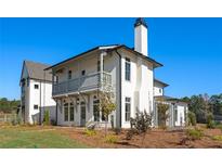 Two-story home with white siding, gray accents, and a balcony at 6001 Stallion Rdg, Douglasville, GA 30135