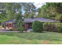 Brick ranch home with carport and well-maintained lawn at 2347 Lavista Ne Rd, Atlanta, GA 30329