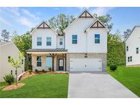 Two-story farmhouse-style home with white siding, brick accents, and a 2-car garage at 738 Crossroad Ct, Powder Springs, GA 30127