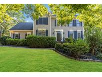 Two story home with a large lawn and mature landscaping at 3187 Green Farm Trl, Dacula, GA 30019