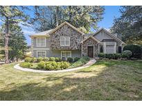 House exterior showcasing stone accents and manicured landscaping at 6280 Wiscasset Nw Pkwy, Dallas, GA 30157