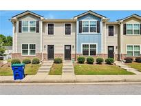 Three-unit townhouse building with gray and blue siding at 4433 Pinscher St, Union City, GA 30291
