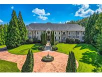Grand estate home with circular driveway and fountain at 9620 Cedar Grove Rd, Chattahoochee Hills, GA 30213