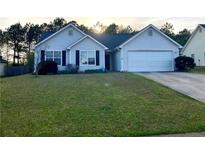 Ranch-style home with a spacious yard and attached garage at 1051 Foxchase Dr, Mcdonough, GA 30253