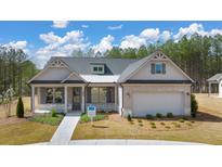 Brick and shingle two-story house with landscaping and a two-car garage at 3749 Tielman St, Snellville, GA 30078