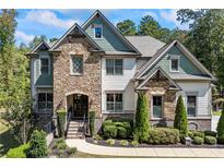 Two-story house with stone and siding exterior at 3111 Old Thompson Mill Rd, Buford, GA 30519