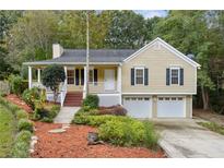 Ranch style home with a two-car garage and landscaped yard at 178 Seals Dr, Dallas, GA 30157