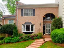 Brick townhouse with bay window, landscaped yard, and walkway at 3021 Margaret Mitchell Dr # 8, Atlanta, GA 30327