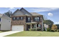 Two-story brick house with landscaped yard at 222 Gallant Fox Way, Acworth, GA 30102