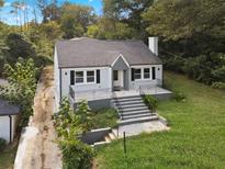 Newly renovated house with gray roof, landscaping, and a spacious yard at 1630 Ezra Church Nw Dr, Atlanta, GA 30314