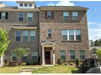 Three-story brick home with front yard at 3370 Reagan Way # 84, Lawrenceville, GA 30044