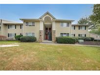 Tan two-story building with stone accents and landscaping at 1468 Briarwood Rd # 805, Brookhaven, GA 30319