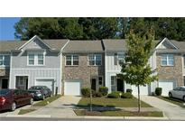 Three-unit townhome building with attached garages at 6336 Kinsland Ct, Lithonia, GA 30058