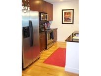 Modern kitchen with stainless steel appliances, dark wood cabinets, and hardwood floors at 44 Peachtree Ne Pl # 424, Atlanta, GA 30309