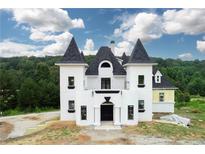 A unique castle-style home with a black roof at 1197 Dee Kennedy Rd, Auburn, GA 30011