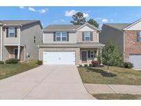 Two-story house with gray siding and a white garage door at 10922 Wheeler Trce, Hampton, GA 30228