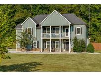 Two-story house with a front porch, stone accents, and a landscaped yard at 133 Gingers Way, Mcdonough, GA 30252