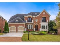 Brick two-story home with two-car garage and landscaped yard at 480 Lancashire Dr, Marietta, GA 30068