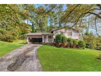 Ranch home with a two-car garage and a nicely landscaped yard at 3664 Broadview Ct, Decatur, GA 30032
