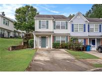 Two-story townhouse with green door and yard at 705 Chase Ln, Mcdonough, GA 30253