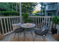 Cozy patio with small table and chairs, perfect for relaxing outdoors at 2706 Suwanee Se Way # 12, Marietta, GA 30067