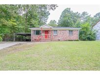 Brick ranch house with red door and carport at 260 Shelburn Dr, Riverdale, GA 30274