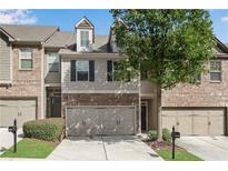 Modern townhome with a two-car garage and attractive landscaping at 4965 Whiteoak Se Walk # 19, Smyrna, GA 30080