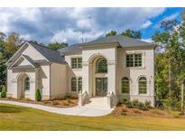 Two story house with front yard landscaping and walkway at 2004 Fontainbleau Dr, Conyers, GA 30094