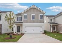 Two-story home with gray siding, white garage door, and landscaping at 3028 Viewpark Cir, Conyers, GA 30013