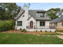 Charming white brick home with a grey roof and welcoming front porch at 348 Sisson Ne Ave, Atlanta, GA 30317