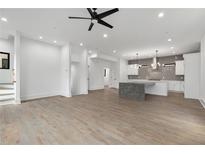 Open living room with hardwood floors, modern kitchen, and high ceilings at 420-D Parkway Ne Dr, Atlanta, GA 30308